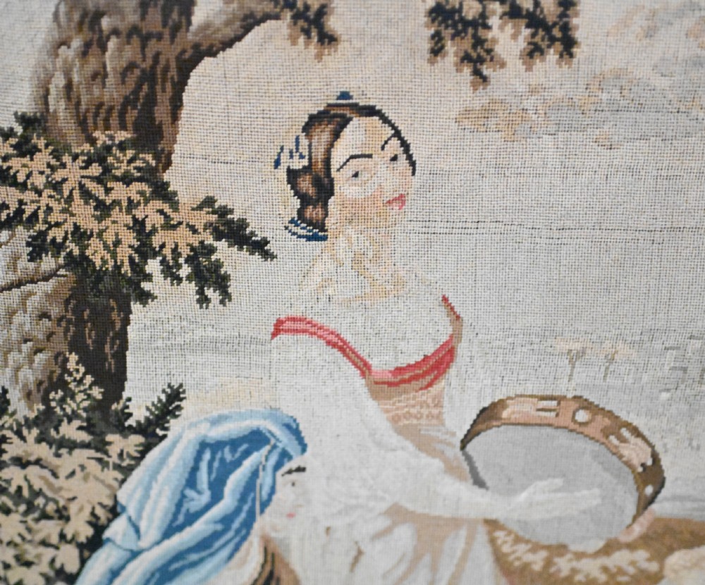 An early Victorian carved wooden fire screen featuring a hand-worked needlepoint tapestry of a pastoral scene set within a scrolled frame. View III