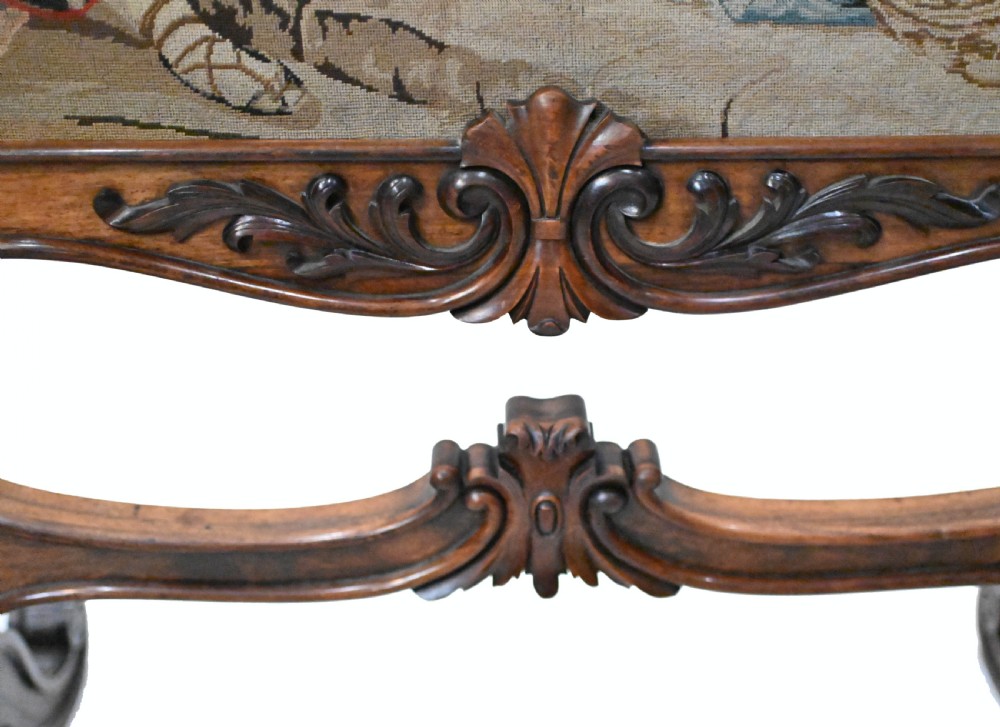An early Victorian carved wooden fire screen featuring a hand-worked needlepoint tapestry of a pastoral scene set within a scrolled frame. View VIII