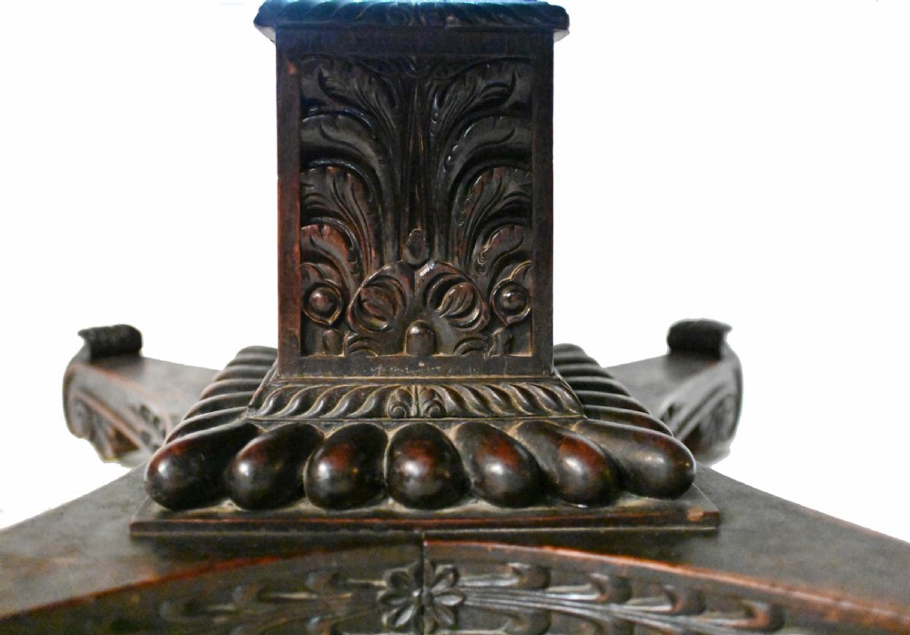 An 1840s Anglo-Indian tilt-top centre table featuring a circular padauk wood top set upon a carved pedestal base. View III