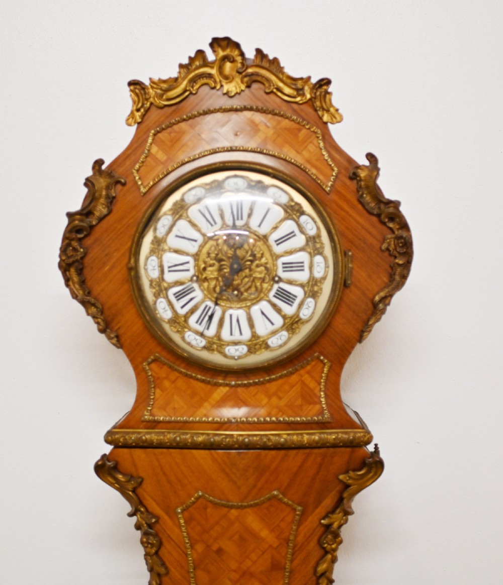 A French longcase clock featuring a waisted kingwood veneer body with gilt-bronze mounts and an enamelled dial. View IV