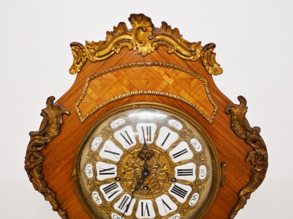 A French longcase clock featuring a waisted kingwood veneer body with gilt-bronze mounts and an enamelled dial. View V