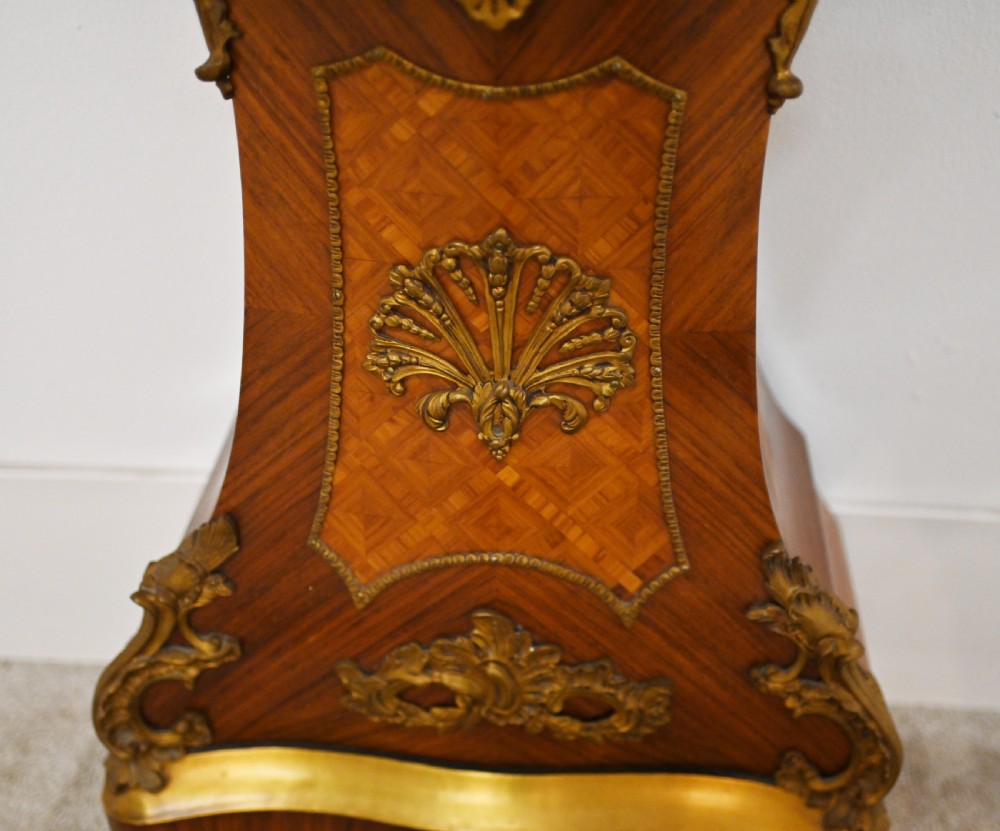 A French longcase clock featuring a waisted kingwood veneer body with gilt-bronze mounts and an enamelled dial. View IX