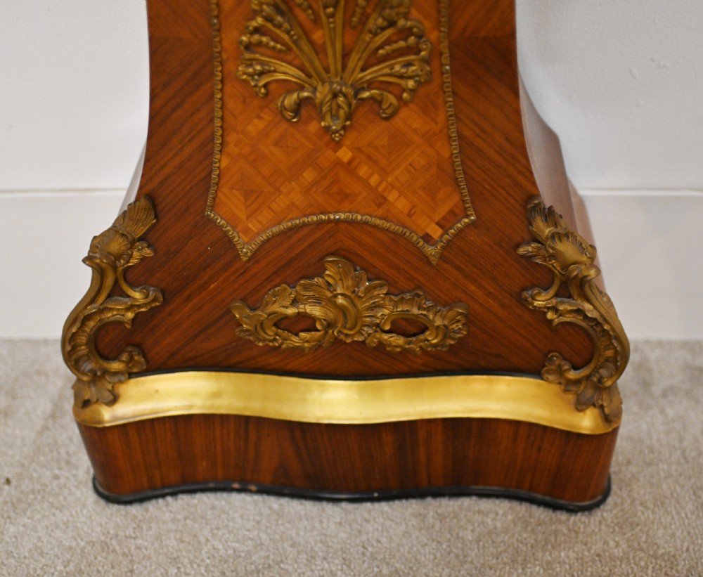 A French longcase clock featuring a waisted kingwood veneer body with gilt-bronze mounts and an enamelled dial. View X