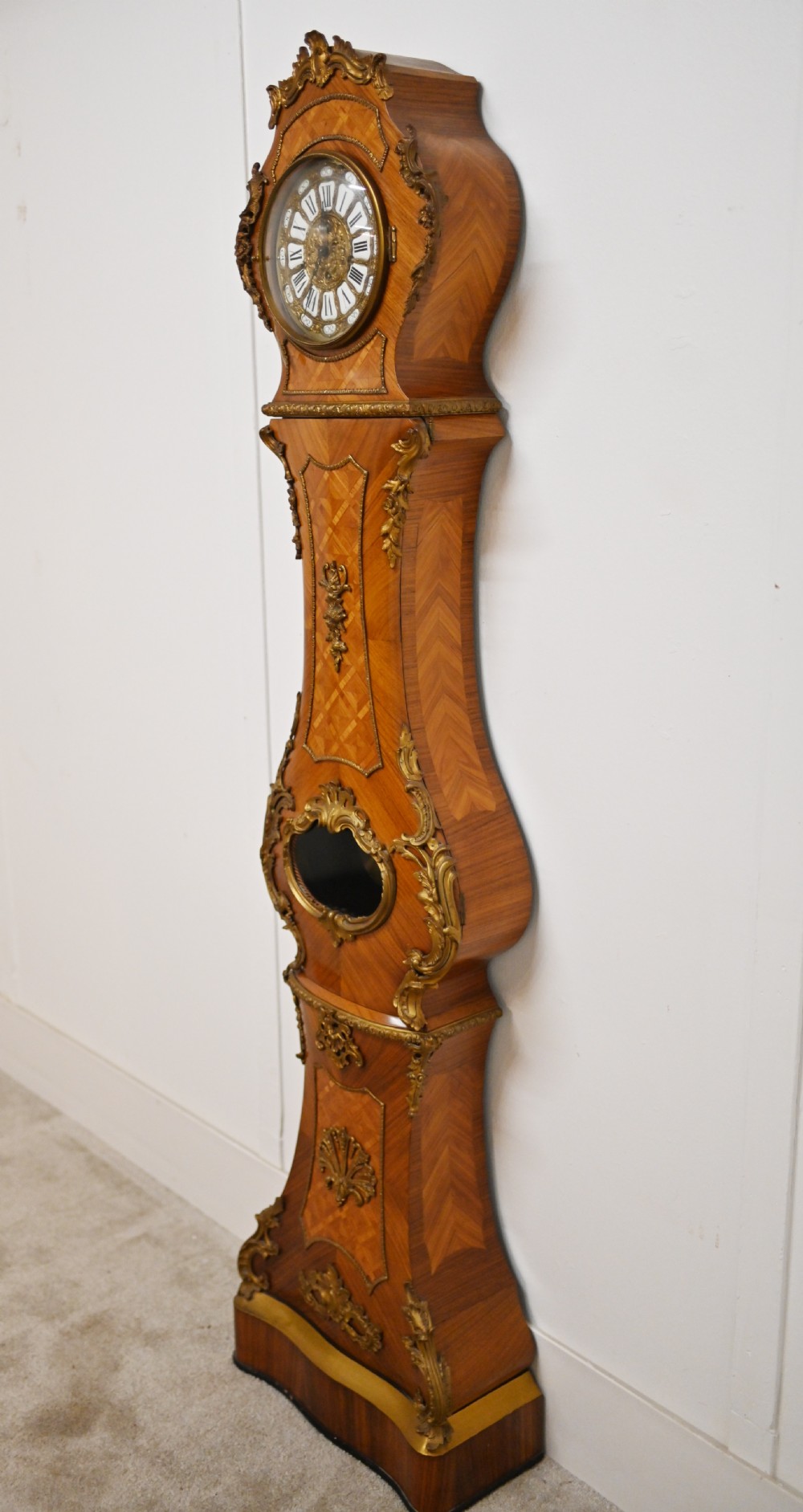 A French longcase clock featuring a waisted kingwood veneer body with gilt-bronze mounts and an enamelled dial. View XII