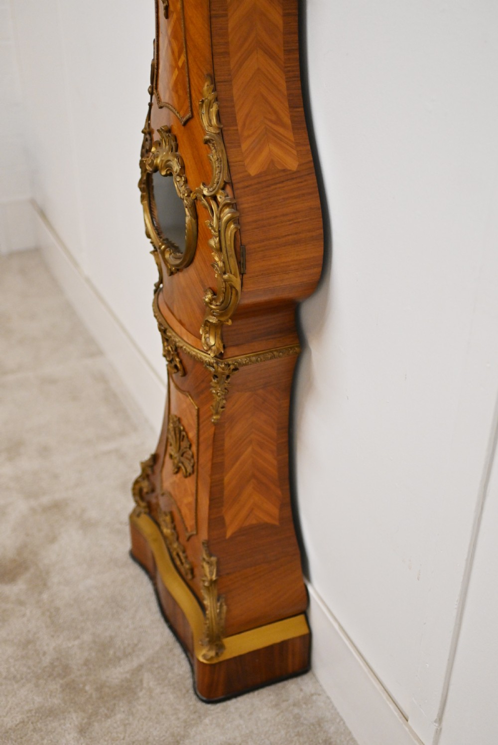 A French longcase clock featuring a waisted kingwood veneer body with gilt-bronze mounts and an enamelled dial. View XIV