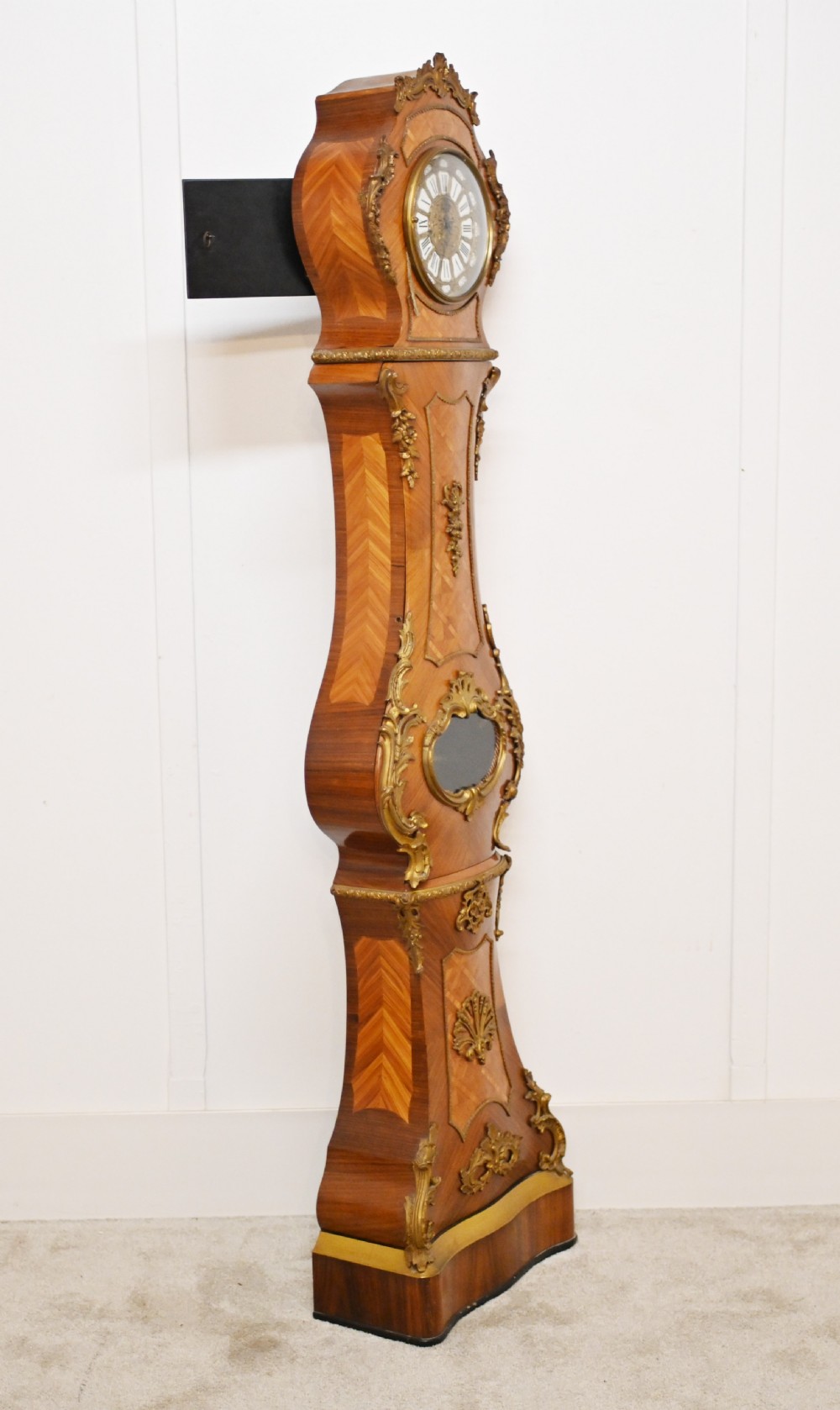 A French longcase clock featuring a waisted kingwood veneer body with gilt-bronze mounts and an enamelled dial. View XVI