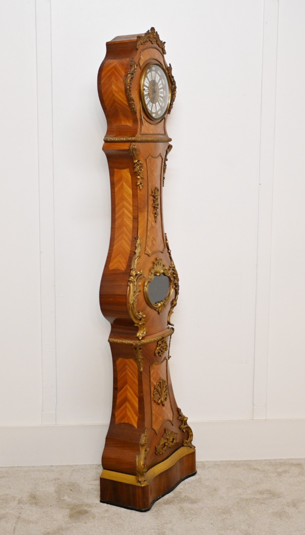 A French longcase clock featuring a waisted kingwood veneer body with gilt-bronze mounts and an enamelled dial. View XVII