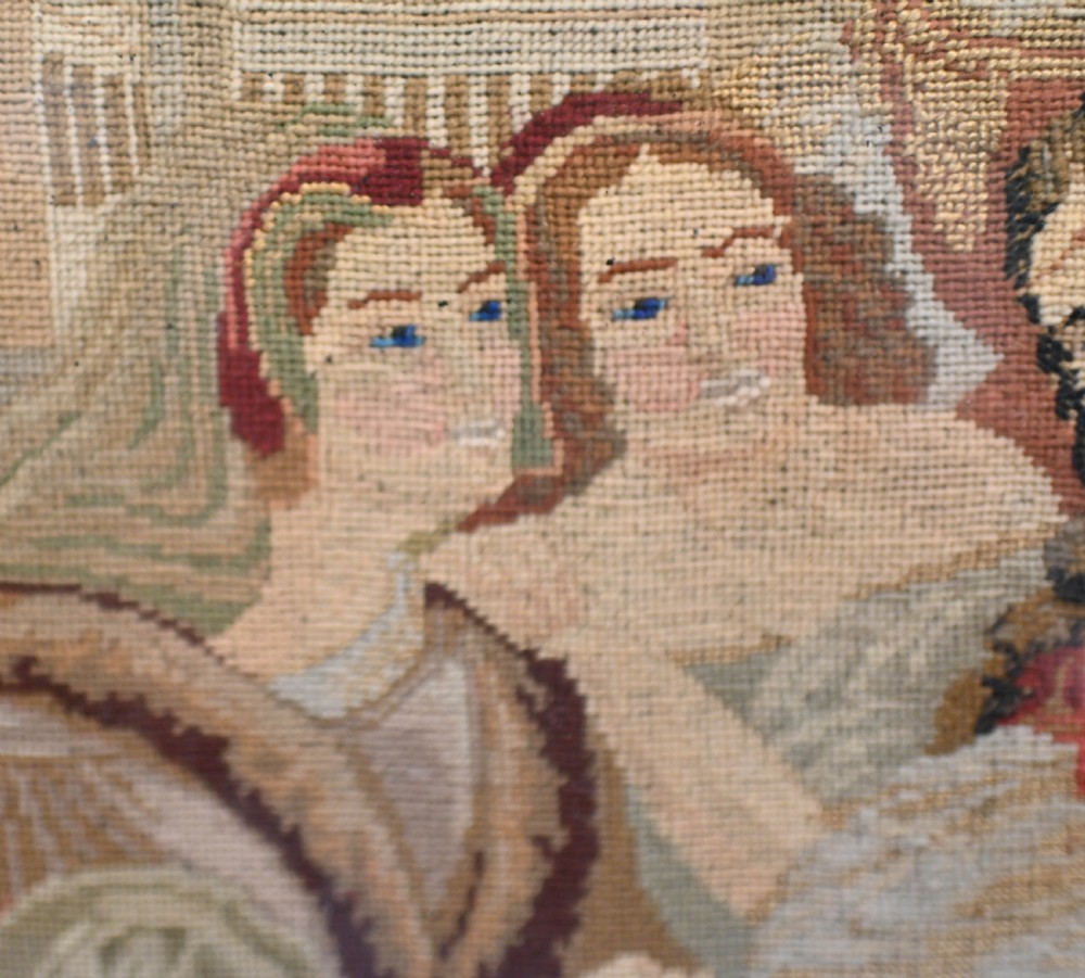 A framed 1865 needlepoint picture depicting a group of courtly maidens in historical dresses, enclosed in an arched gilt black glass mat and polished walnut frame. View VIII
