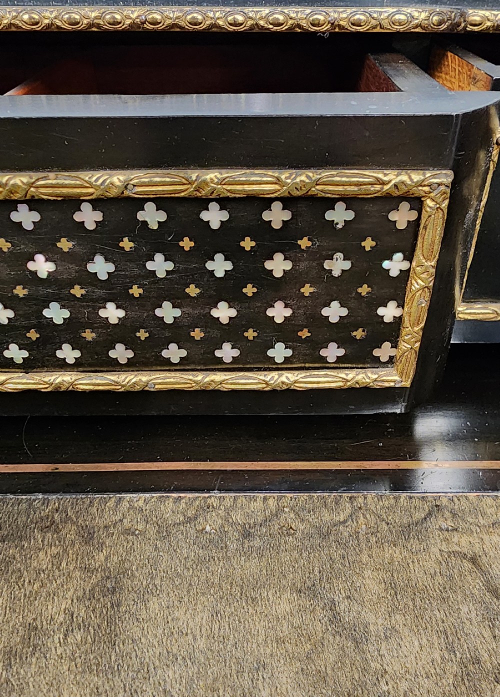 A French Napoleon III ebonised writing desk featuring gilt bronze mounts, brass inlay panels, turned legs, and a raised top superstructure with a brass gallery. View VIII