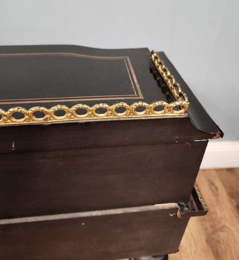A French Napoleon III ebonised writing desk featuring gilt bronze mounts, brass inlay panels, turned legs, and a raised top superstructure with a brass gallery. View XV