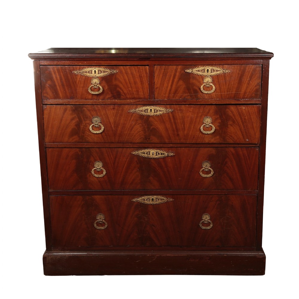 A 19th-century Biedermeier flame mahogany chest of drawers featuring decorative brass escutcheons and drop ring handles.