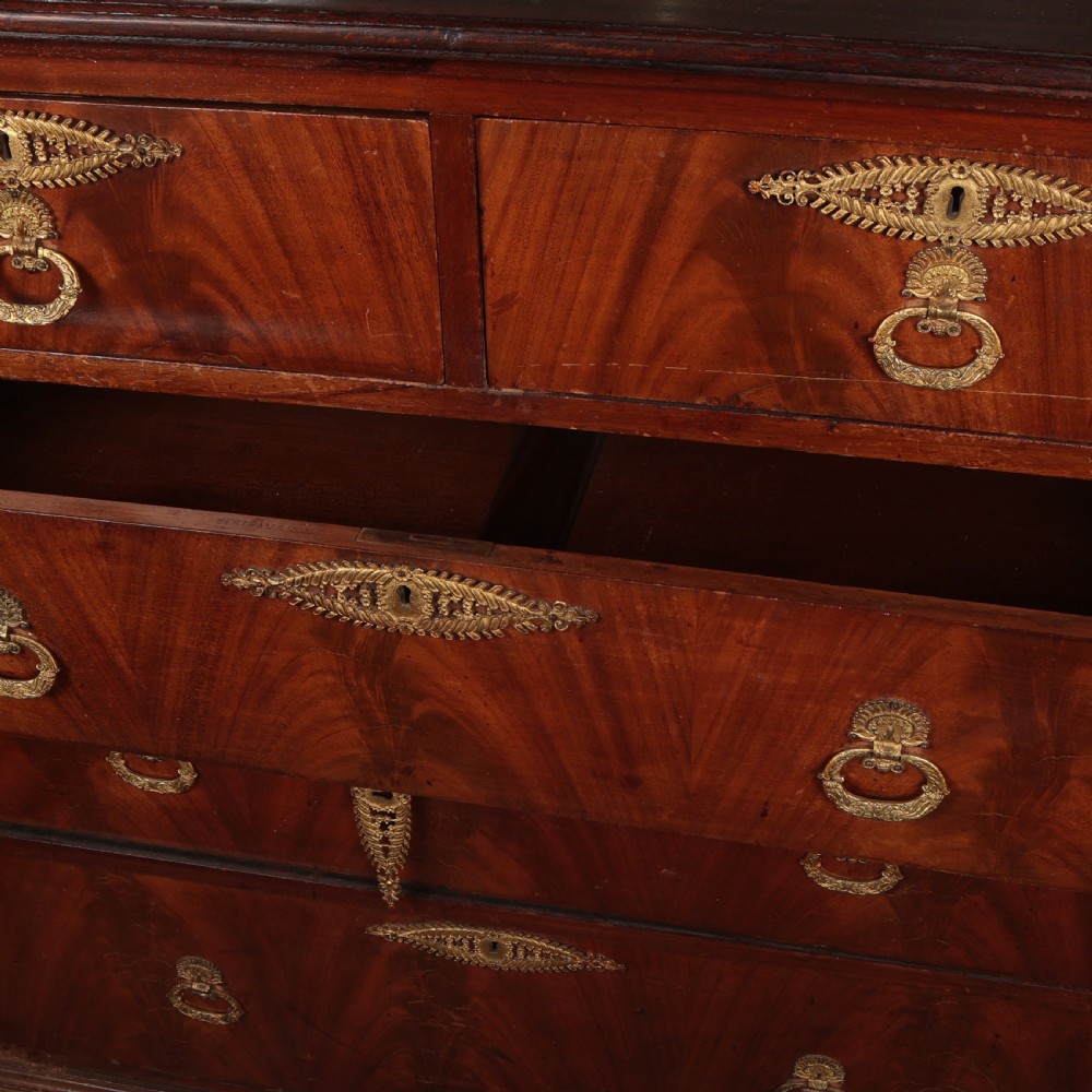 A 19th-century Biedermeier flame mahogany chest of drawers featuring decorative brass escutcheons and drop ring handles. View III