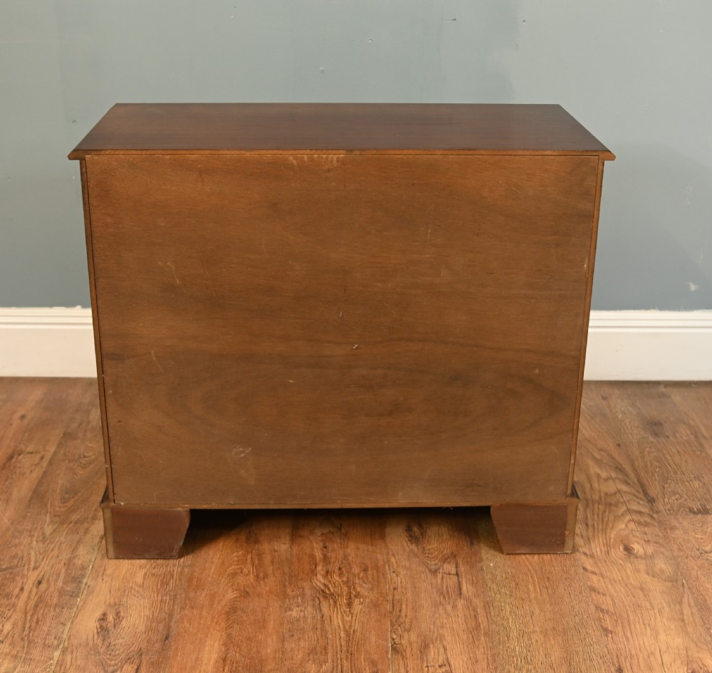 An early Victorian dark mahogany side cabinet featuring two panelled cupboard doors with brass keyhole escutcheons and a plinth base. View VI