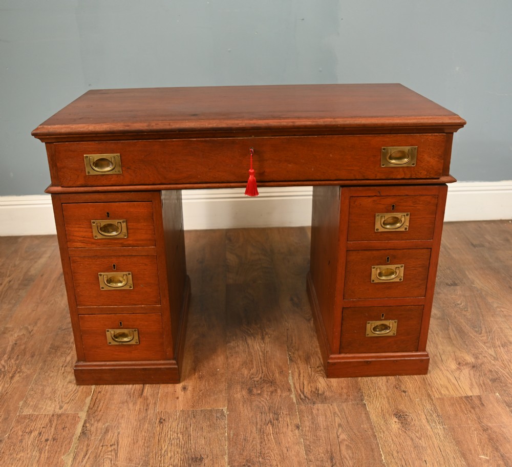 A Victorian mahogany campaign pedestal desk featuring flush brass handles, multiple drawers, and a polished timber surface. View II