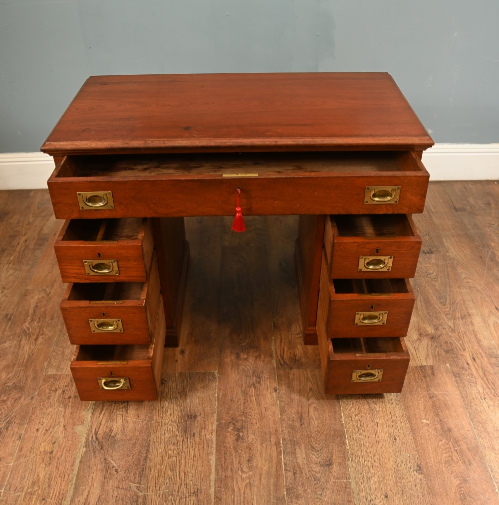 A Victorian mahogany campaign pedestal desk featuring flush brass handles, multiple drawers, and a polished timber surface. View IV