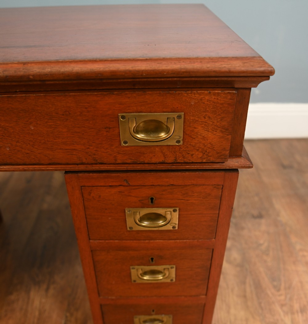 A Victorian mahogany campaign pedestal desk featuring flush brass handles, multiple drawers, and a polished timber surface. View VI