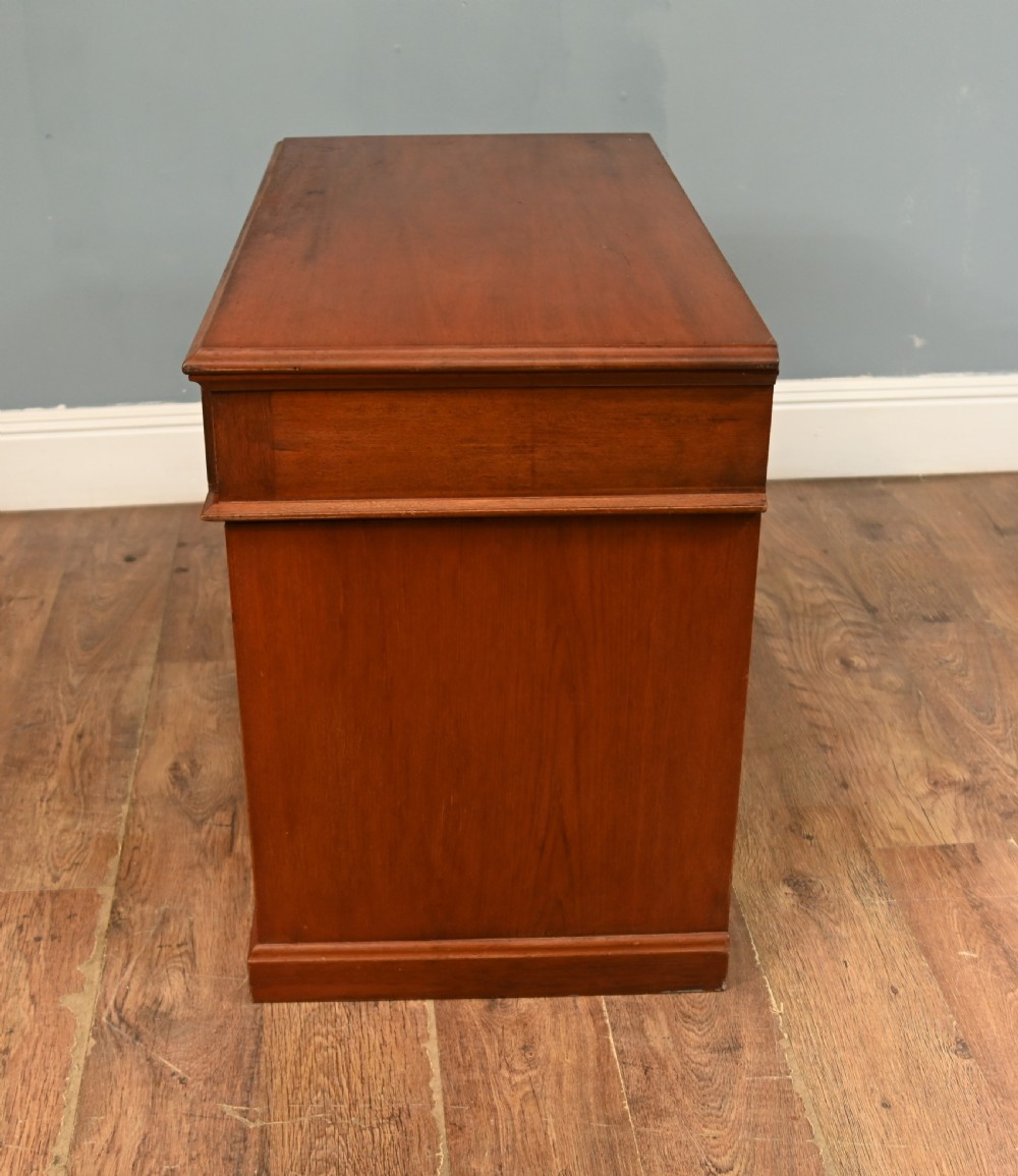 A Victorian mahogany campaign pedestal desk featuring flush brass handles, multiple drawers, and a polished timber surface. View VIII