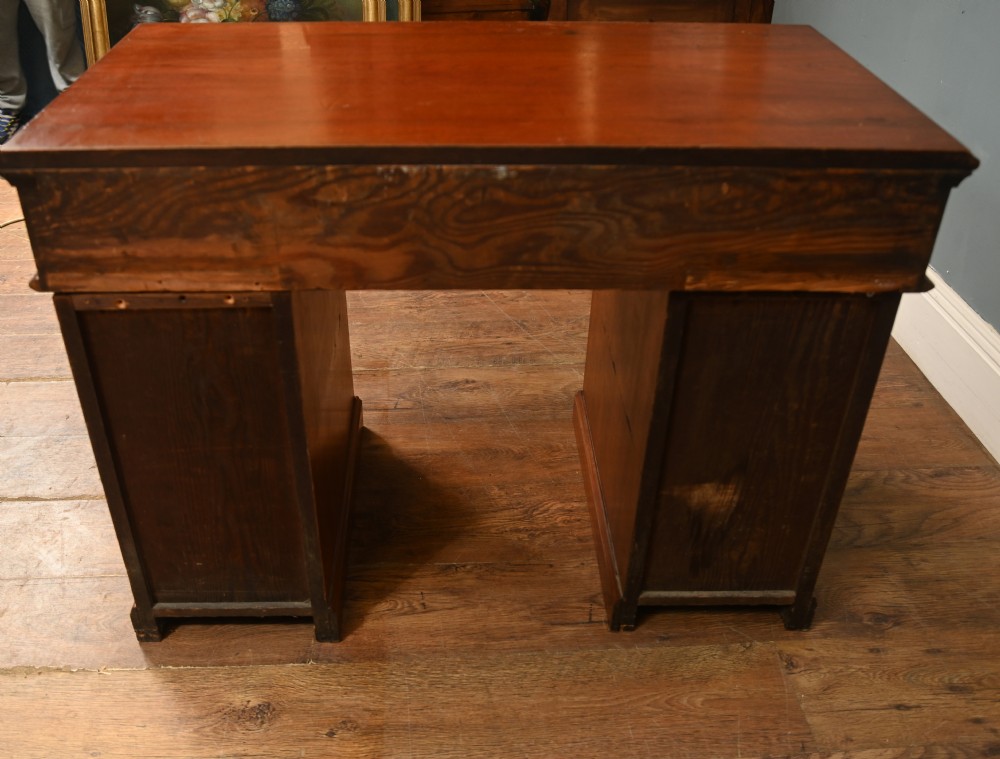 A Victorian mahogany campaign pedestal desk featuring flush brass handles, multiple drawers, and a polished timber surface. View X