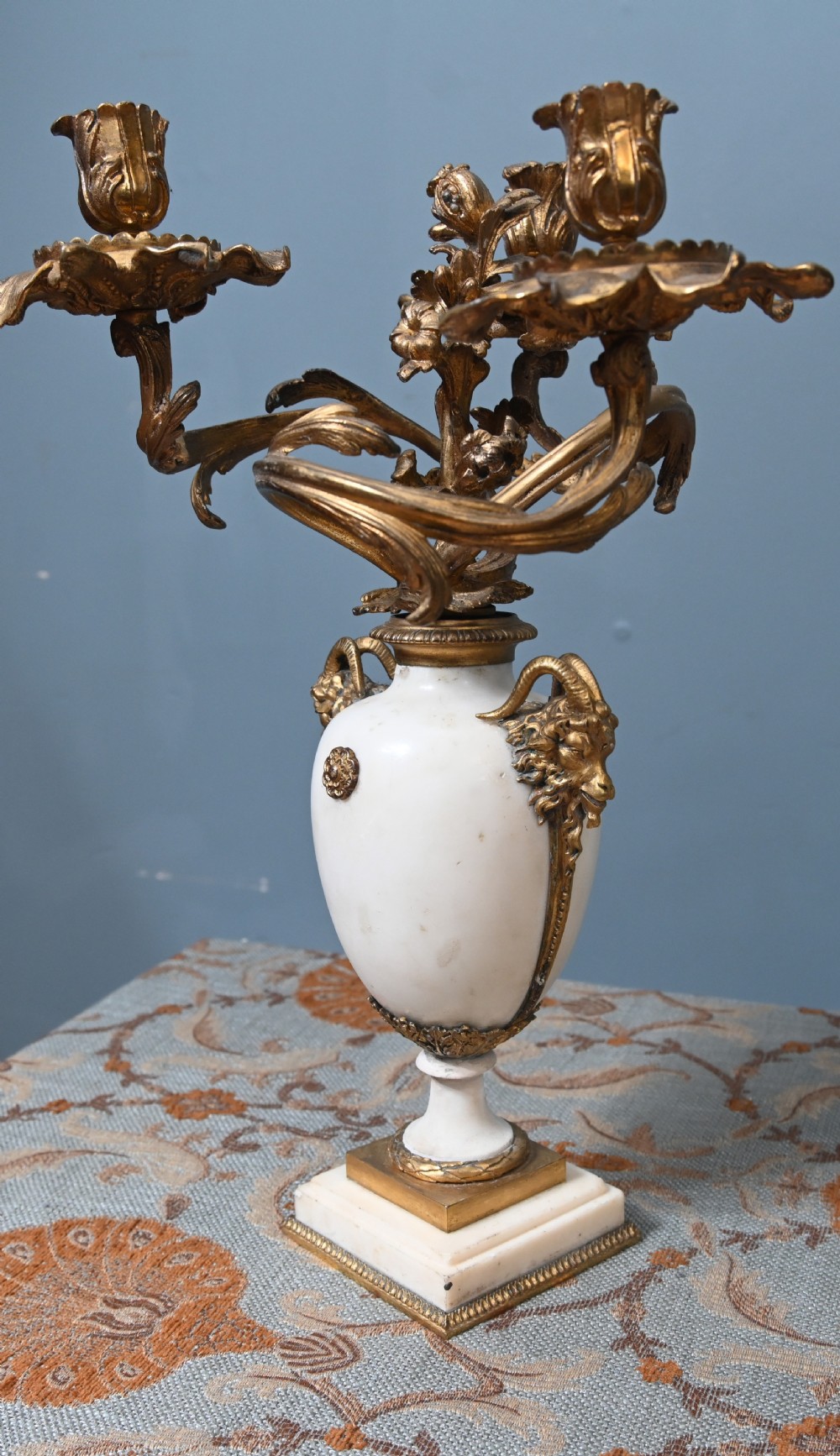 A pair of late 19th-century French Louis XVI Revival gilt bronze and white marble three-arm candelabras featuring urn-shaped bases and floral branch detailing. View VII