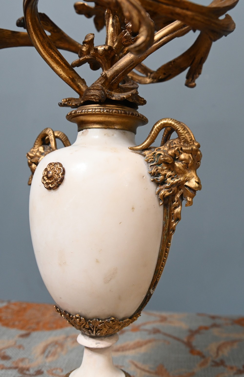 A pair of late 19th-century French Louis XVI Revival gilt bronze and white marble three-arm candelabras featuring urn-shaped bases and floral branch detailing. View XI