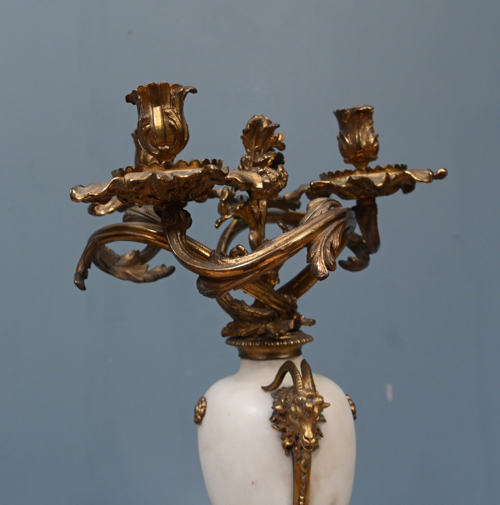 A pair of late 19th-century French Louis XVI Revival gilt bronze and white marble three-arm candelabras featuring urn-shaped bases and floral branch detailing. View XIII