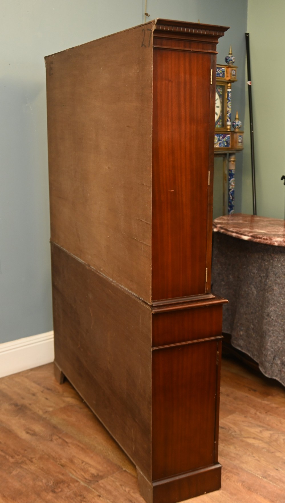 A Georgian Revival mahogany bookcase cabinet featuring a three-door astragal glazed upper section above three drawers and flame mahogany cupboard doors. View XI