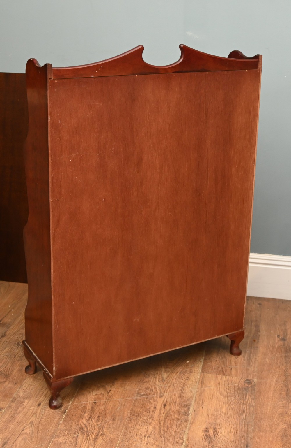 A pair of open mahogany waterfall bookcases featuring three graduated shelves, shaped side profiles, and two lower drawers. View IX