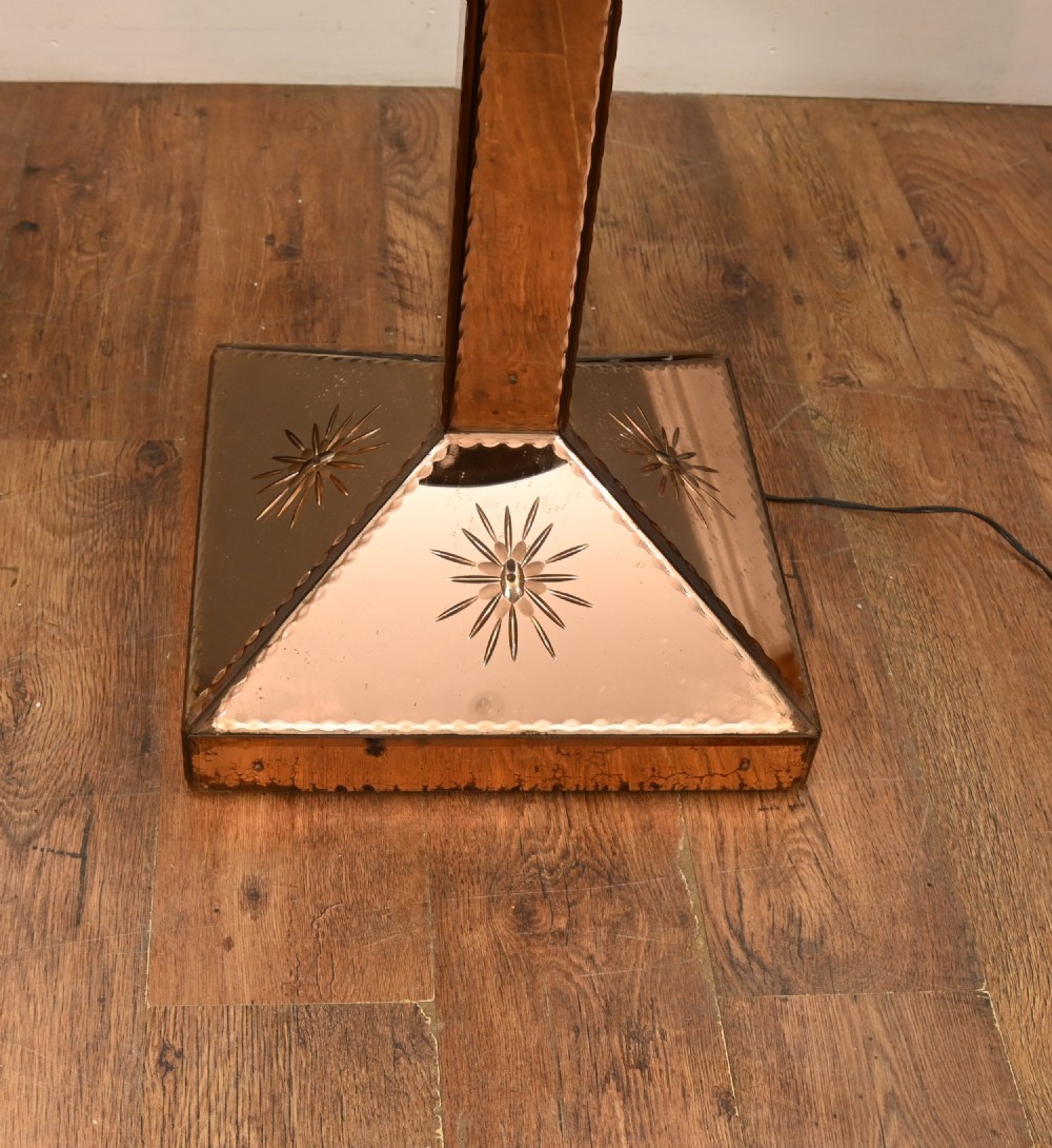 An Art Deco floor lamp featuring peach-tinted mirrored glass panels with etched starburst designs, a central black circular glass cocktail shelf, and a square pyramidal base. View III