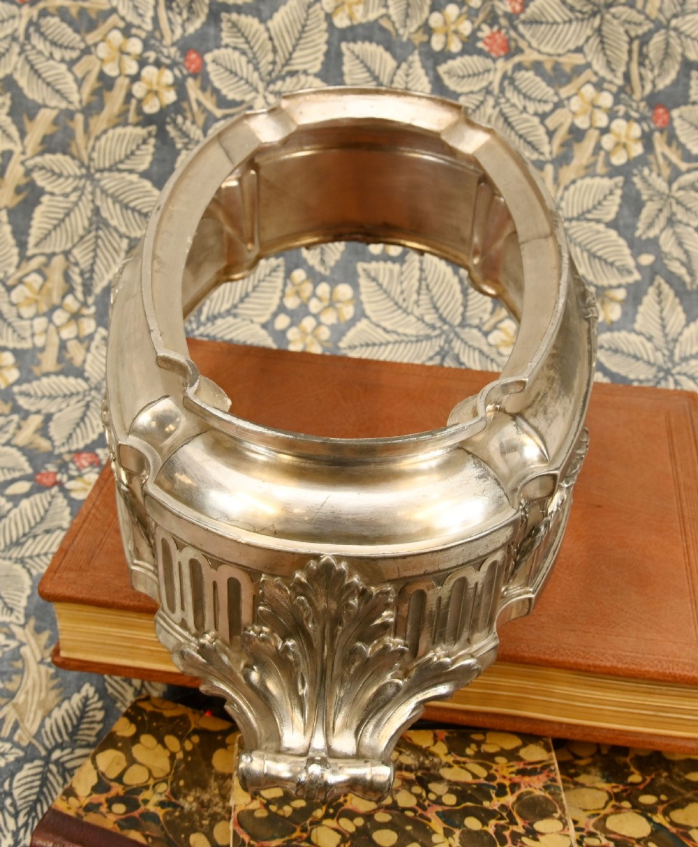 An oval Neoclassical silver-plated jardiniere featuring ribbon bow motifs, hanging laurel swags, twin end handles, and an engraved central medallion dated 1909. View VII