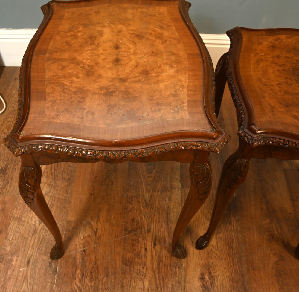 A set of three graduated burr walnut nest tables featuring carved serpentine edges, cabriole legs with carved knees, and claw-and-ball feet. View III