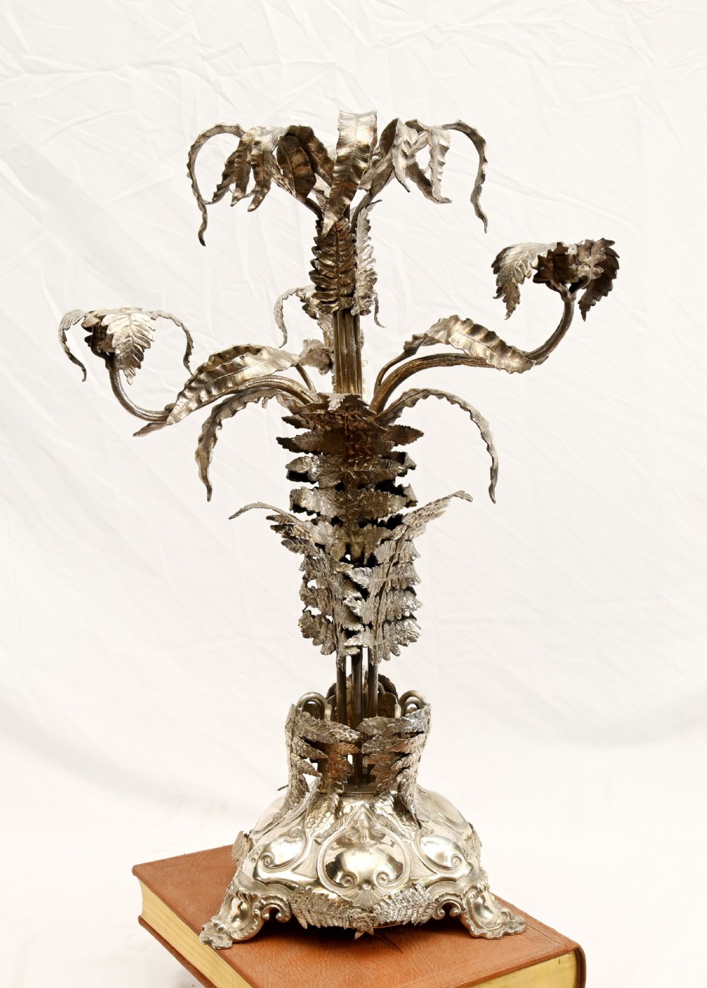 A silver-plated three-light candelabra designed in the shape of a palm tree with detailed foliate leaves and a scrolled base. View III