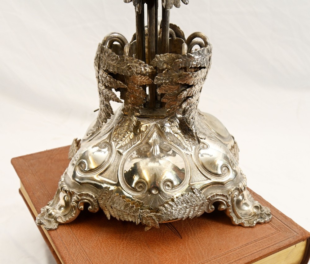 A silver-plated three-light candelabra designed in the shape of a palm tree with detailed foliate leaves and a scrolled base. View IV