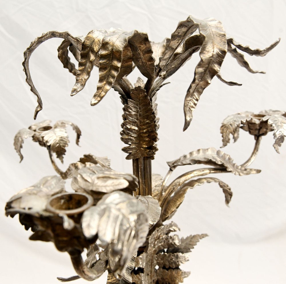A silver-plated three-light candelabra designed in the shape of a palm tree with detailed foliate leaves and a scrolled base. View IX