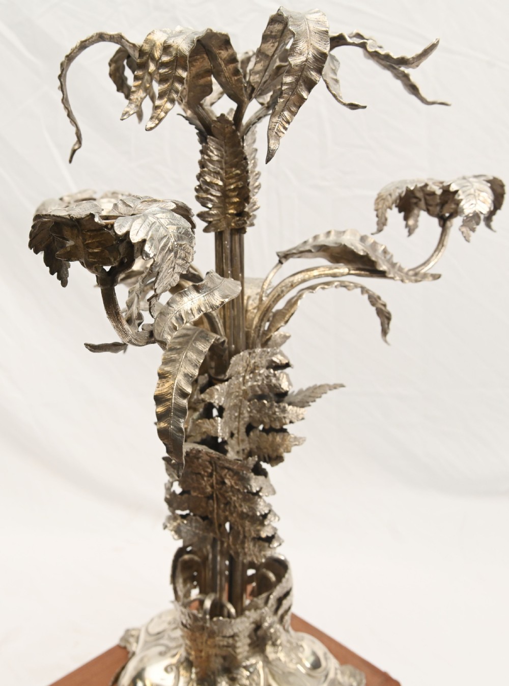A silver-plated three-light candelabra designed in the shape of a palm tree with detailed foliate leaves and a scrolled base. View XI