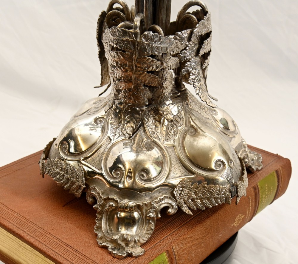 A silver-plated three-light candelabra designed in the shape of a palm tree with detailed foliate leaves and a scrolled base. View XII