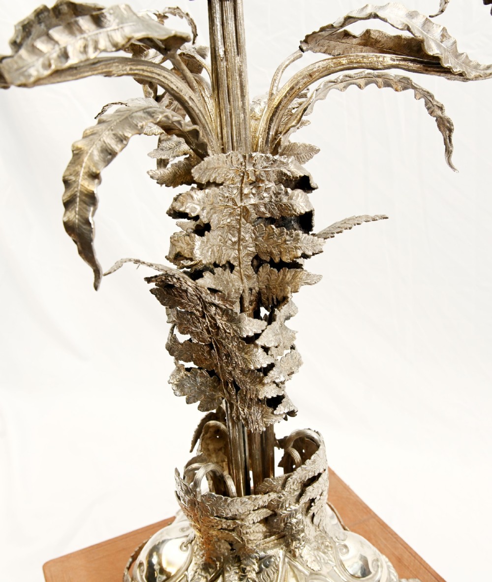 A silver-plated three-light candelabra designed in the shape of a palm tree with detailed foliate leaves and a scrolled base. View XIII