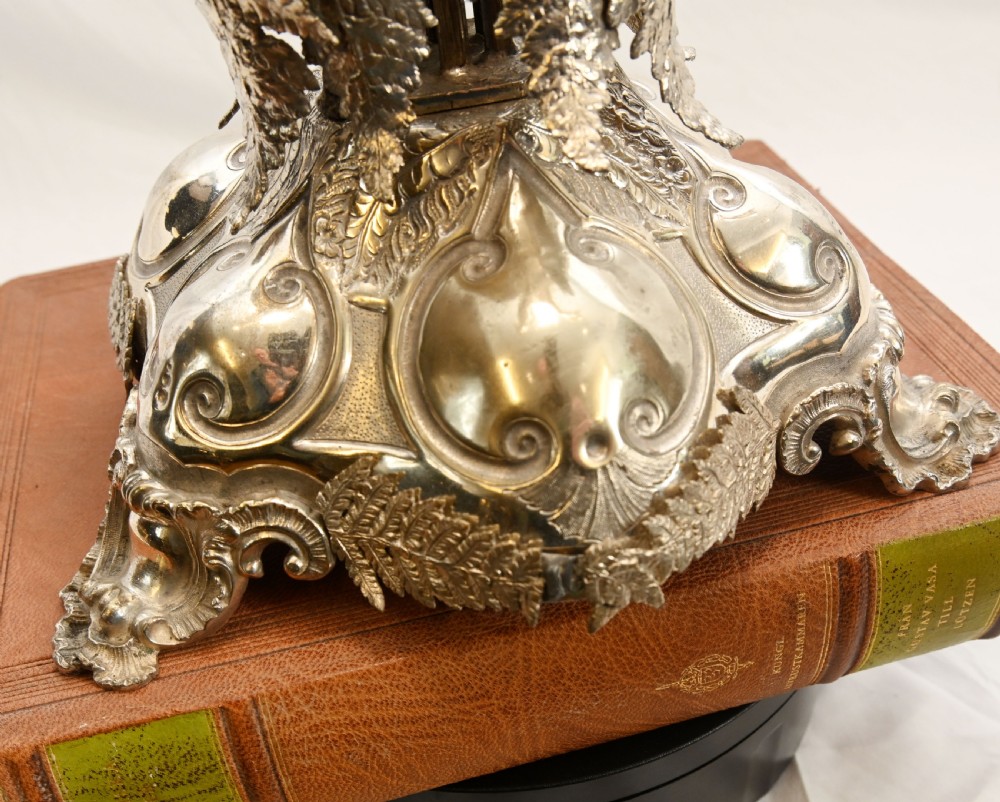 A silver-plated three-light candelabra designed in the shape of a palm tree with detailed foliate leaves and a scrolled base. View XV