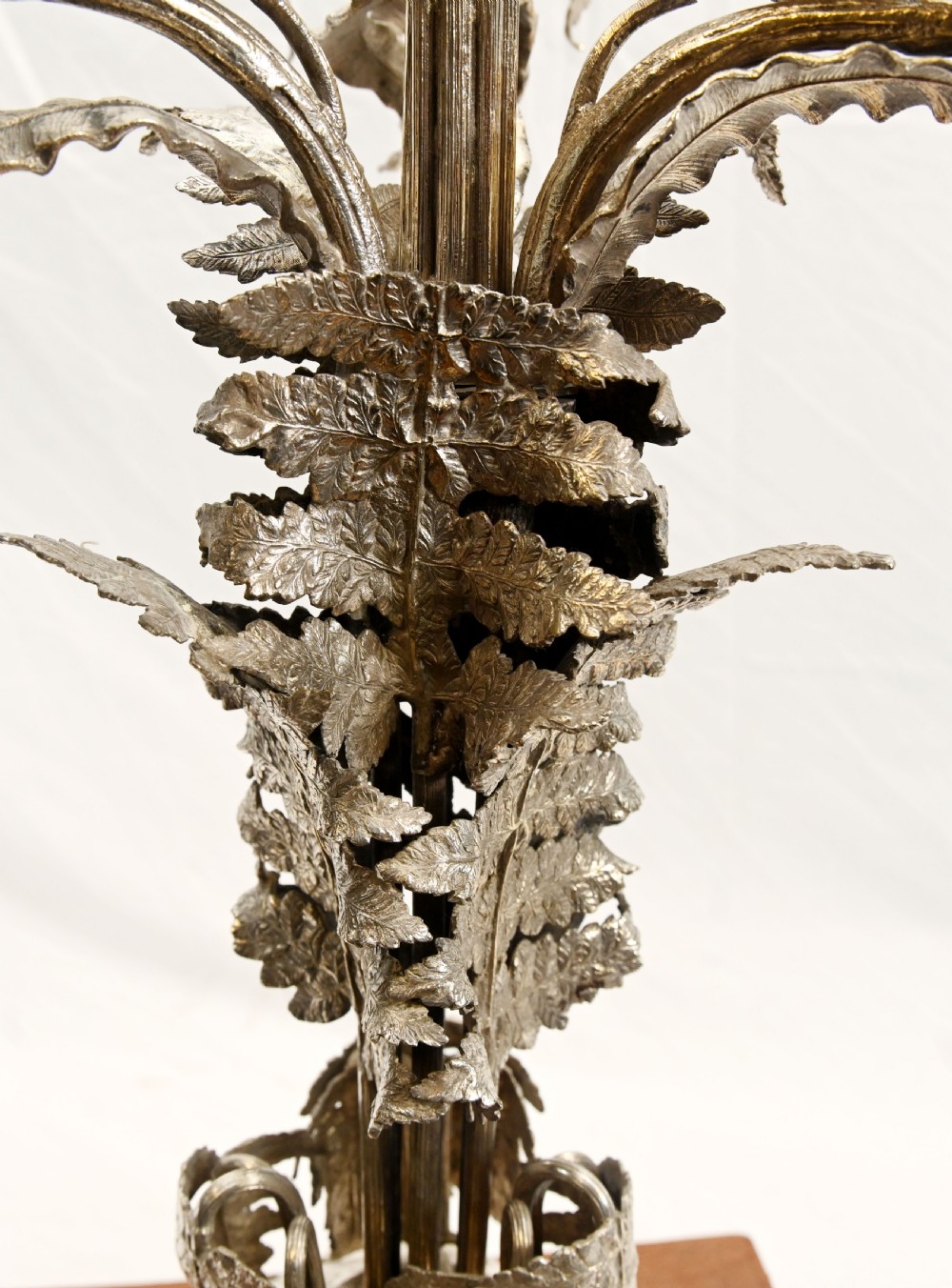 A silver-plated three-light candelabra designed in the shape of a palm tree with detailed foliate leaves and a scrolled base. View XVII