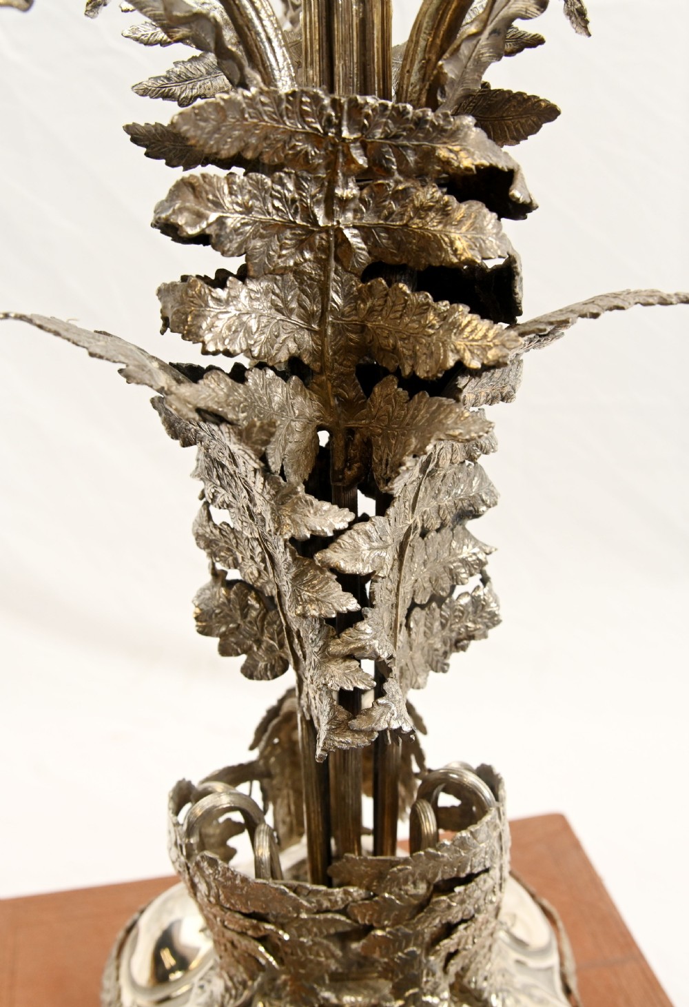 A silver-plated three-light candelabra designed in the shape of a palm tree with detailed foliate leaves and a scrolled base. View XVIII