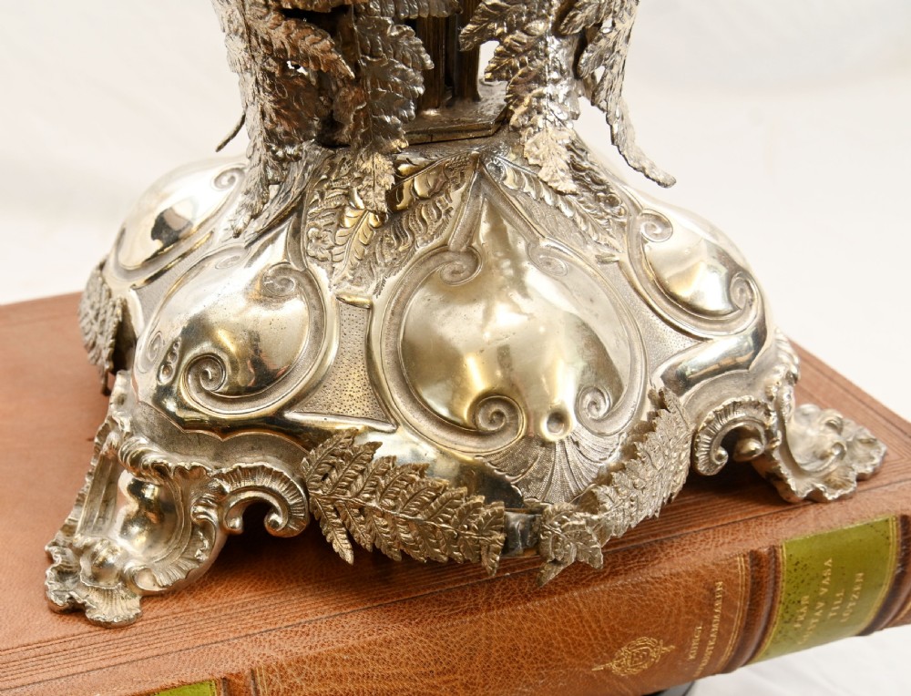 A silver-plated three-light candelabra designed in the shape of a palm tree with detailed foliate leaves and a scrolled base. View XIX