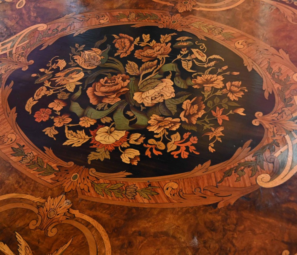 A French Louis XV style centre table featuring intricate floral marquetry, a serpentine top, cabriole legs, and gilded bronze mounts. View VI