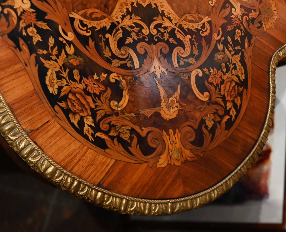 A French Louis XV style centre table featuring intricate floral marquetry, a serpentine top, cabriole legs, and gilded bronze mounts. View VIII