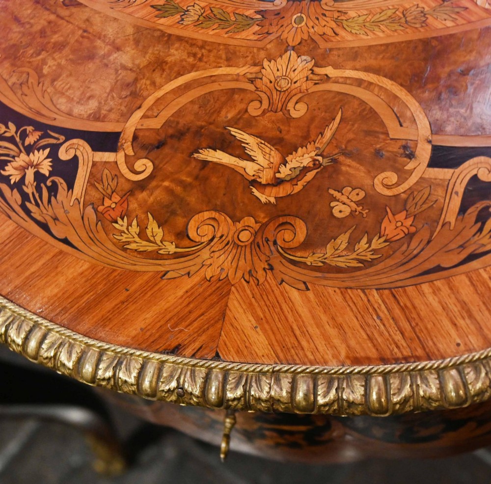 A French Louis XV style centre table featuring intricate floral marquetry, a serpentine top, cabriole legs, and gilded bronze mounts. View IX