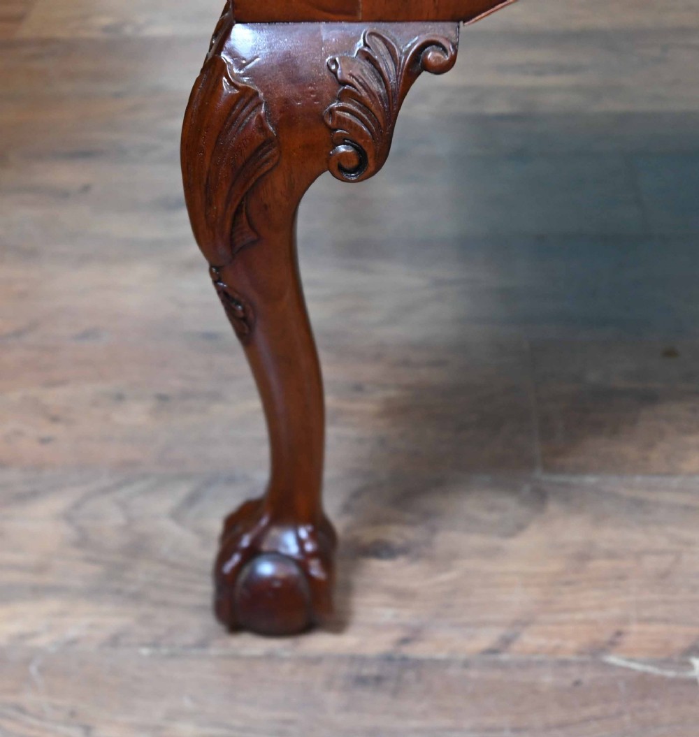 Late Victorian mahogany writing desk featuring a tan gilt-tooled leather inset top, brass swan-neck handles, and carved cabriole legs with ball-and-claw feet. View VI