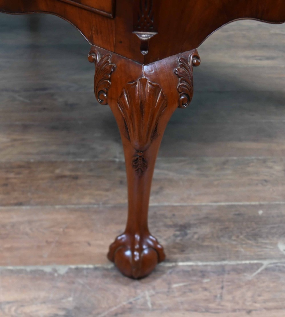 Late Victorian mahogany writing desk featuring a tan gilt-tooled leather inset top, brass swan-neck handles, and carved cabriole legs with ball-and-claw feet. View IX