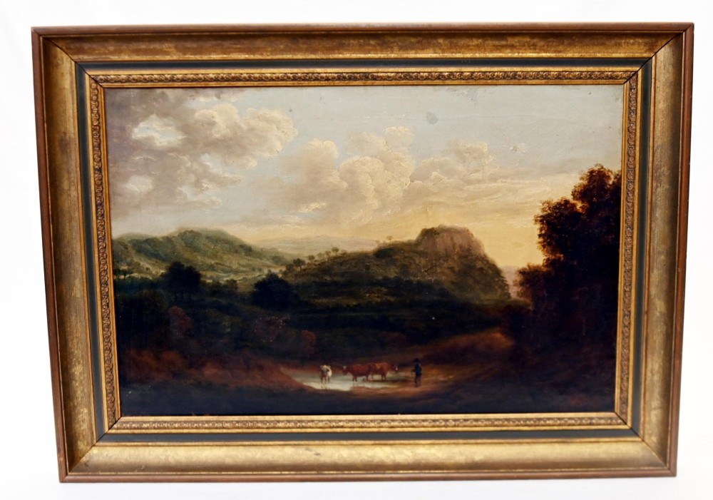 A Victorian oil painting depicting cattle near a stream in a pastoral landscape with hills and castle ruins, housed within a gilt and dark wooden frame.
