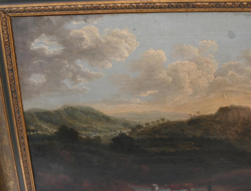 A Victorian oil painting depicting cattle near a stream in a pastoral landscape with hills and castle ruins, housed within a gilt and dark wooden frame. View IV