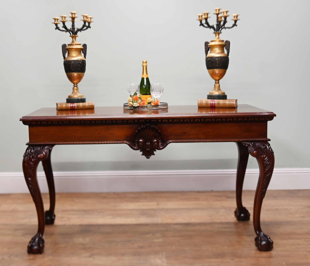 A rectangular Chippendale revival mahogany console table featuring a central carved apron shell detail, cabriole legs, and carved claw and ball feet. View II