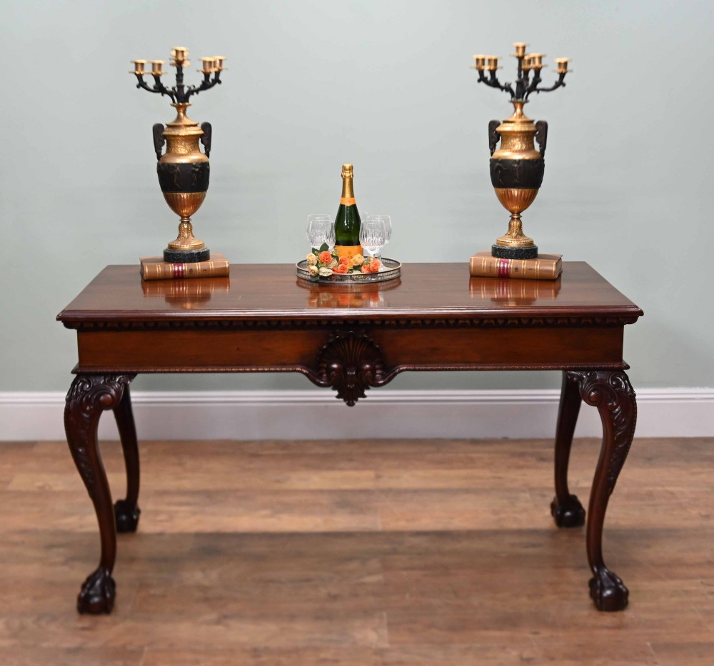 A rectangular Chippendale revival mahogany console table featuring a central carved apron shell detail, cabriole legs, and carved claw and ball feet. View III