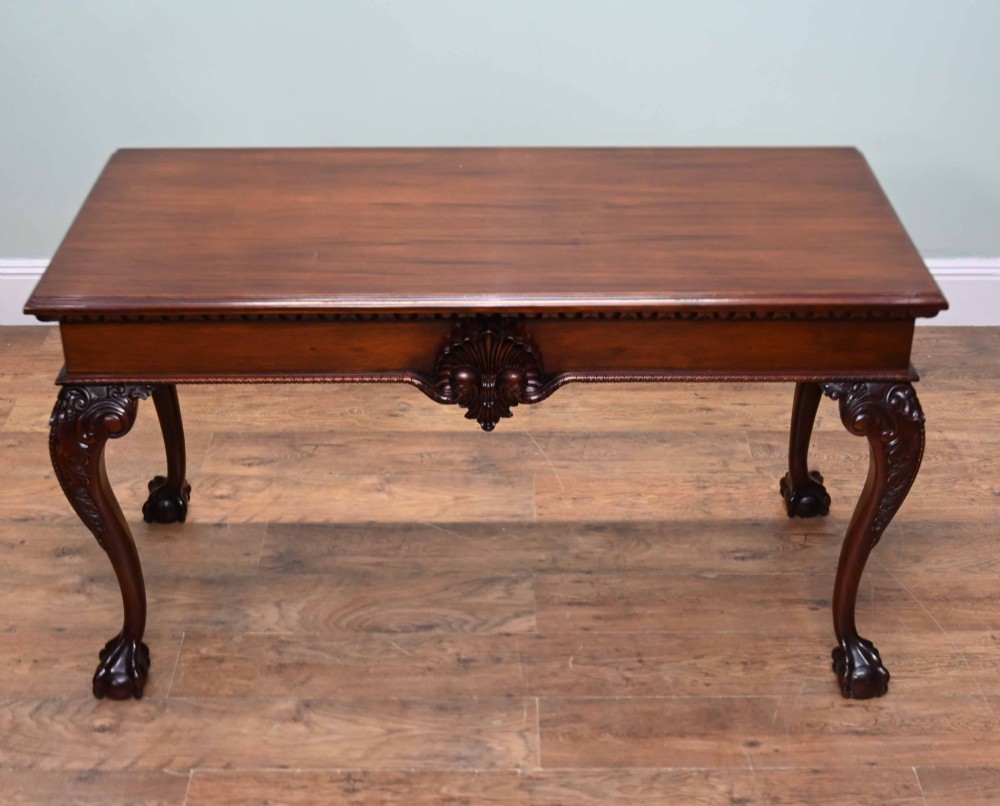 A rectangular Chippendale revival mahogany console table featuring a central carved apron shell detail, cabriole legs, and carved claw and ball feet. View IV